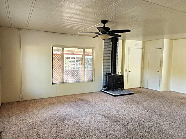 a view of a livingroom with a ceiling fan and window