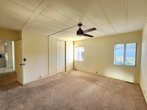 a view of empty room with ceiling fan