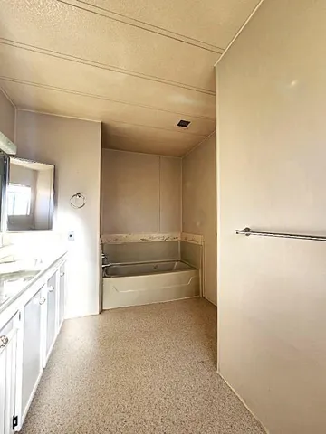 a view of a house with a small yard plants and large tree