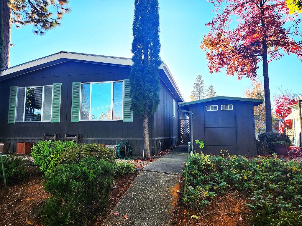 10113 Shamrock Lode Grass Valley, CA 95949 - Photo 30 of 34 a view of a house with a small yard plants and large tree