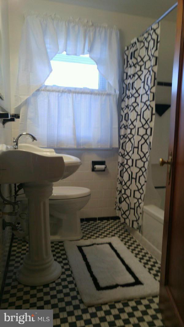 2015 Crestview Road Baltimore, MD 21239 - Photo 11 of 21 a bathroom with a sink toilet and window