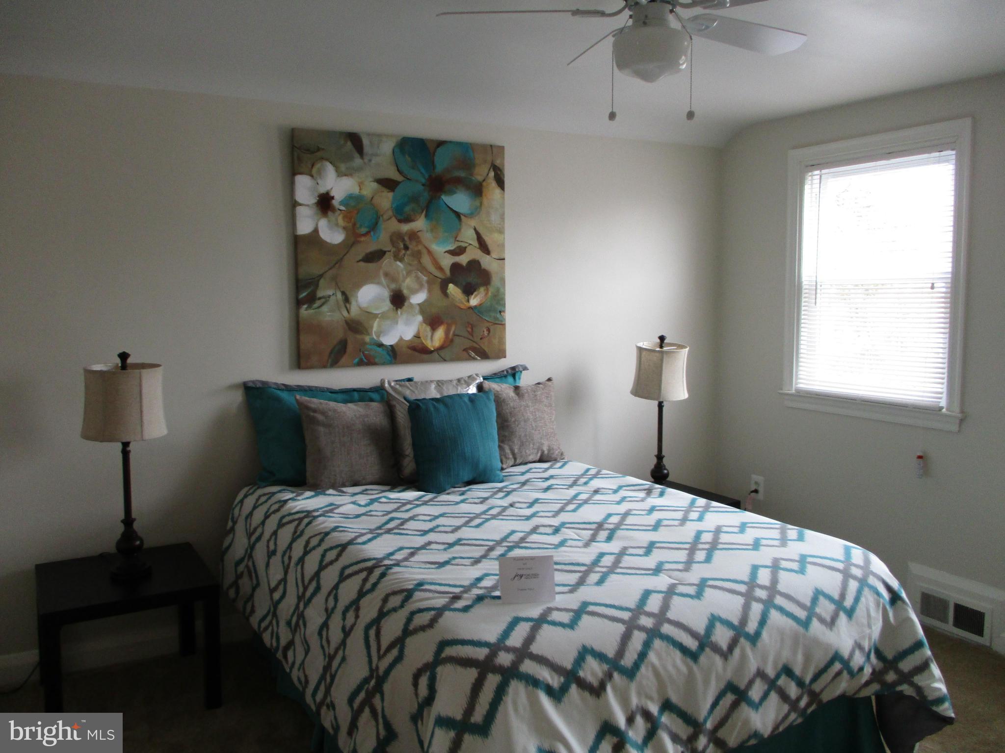 2015 Crestview Road Baltimore, MD 21239 - Photo 14 of 21 a bedroom with a bed and a painting on the wall