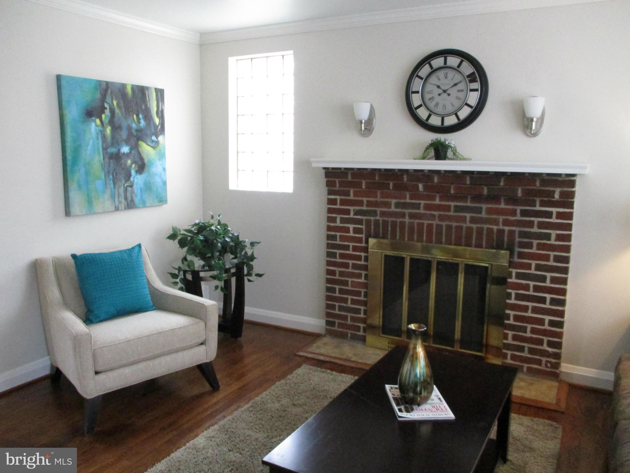 2015 Crestview Road Baltimore, MD 21239 - Photo 3 of 21 a living room with furniture a clock and a fireplace