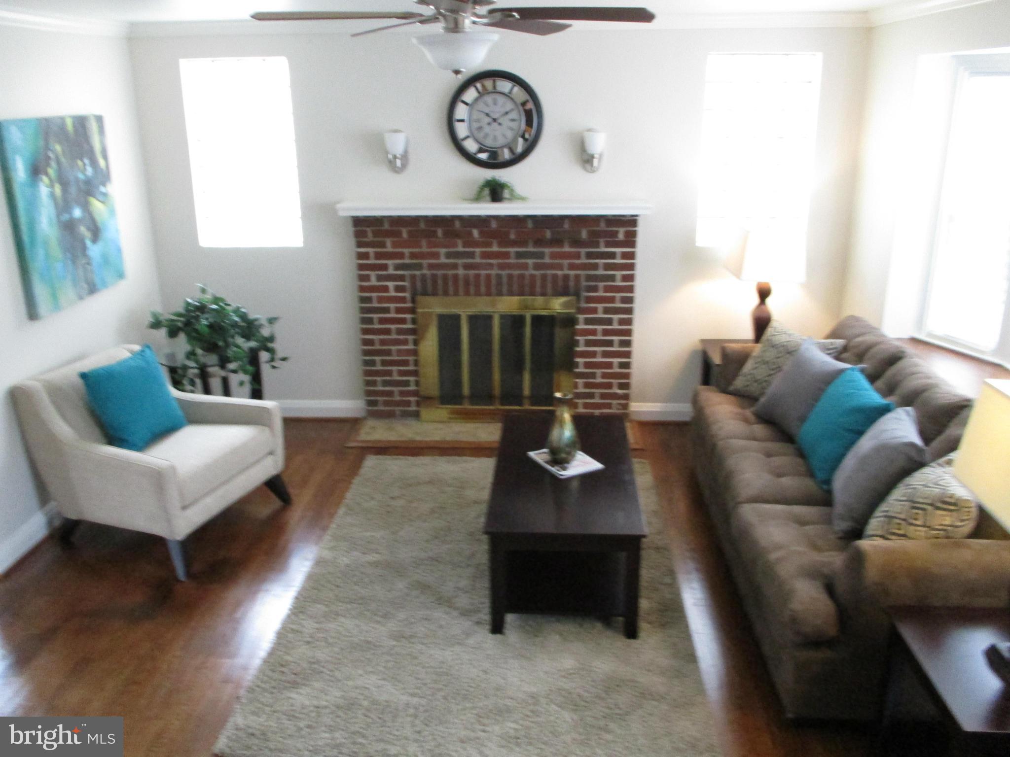 2015 Crestview Road Baltimore, MD 21239 - Photo 4 of 21 a living room with furniture a rug a fireplace and a large window