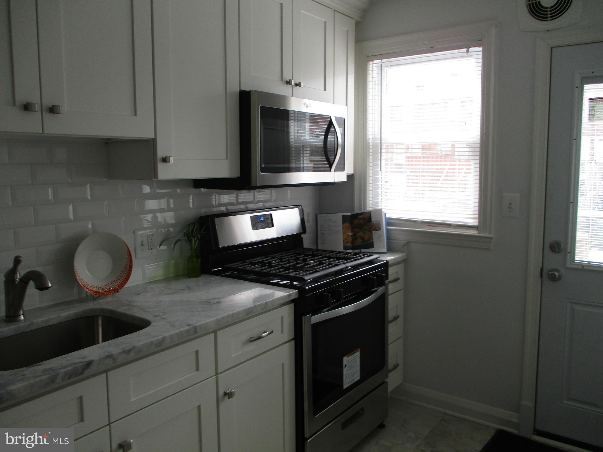 2015 Crestview Road Baltimore, MD 21239 - Photo 9 of 21 a kitchen with granite countertop a stove and a sink