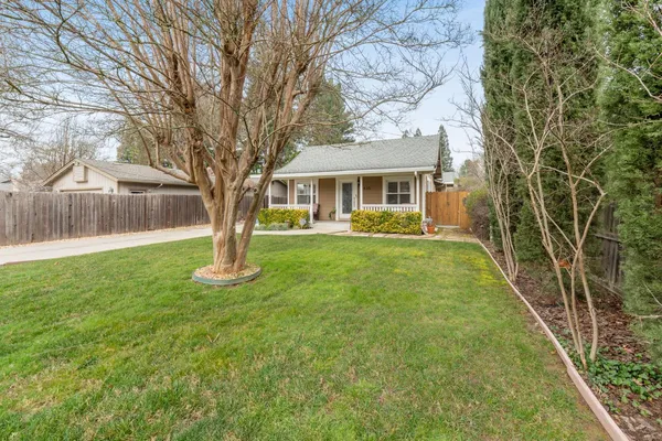 a front view of house with yard and green space