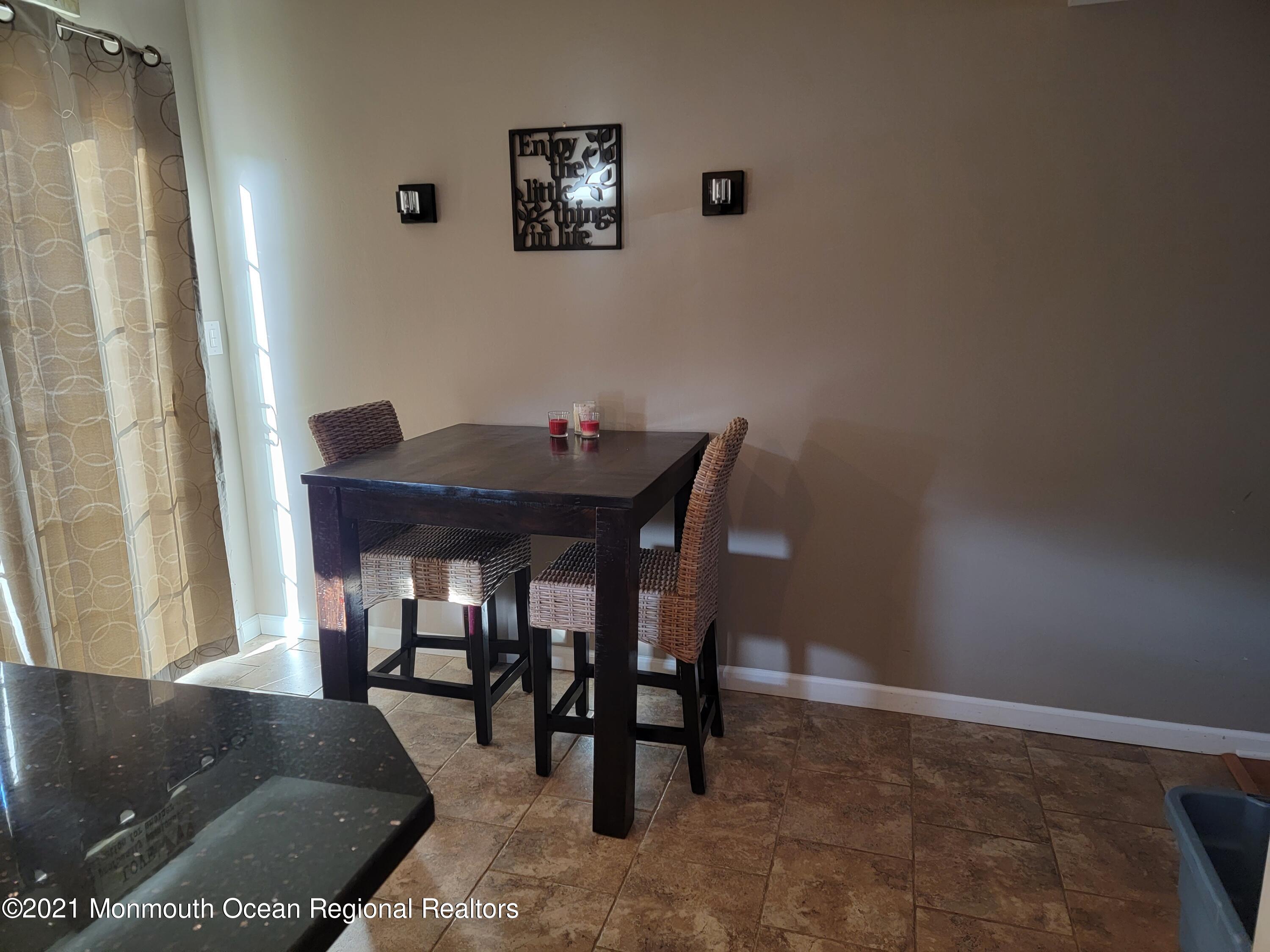 76 Greenwood Loop Road Brick, NJ 08724 - Photo 11 of 24 a living room with furniture and a painting on the wall