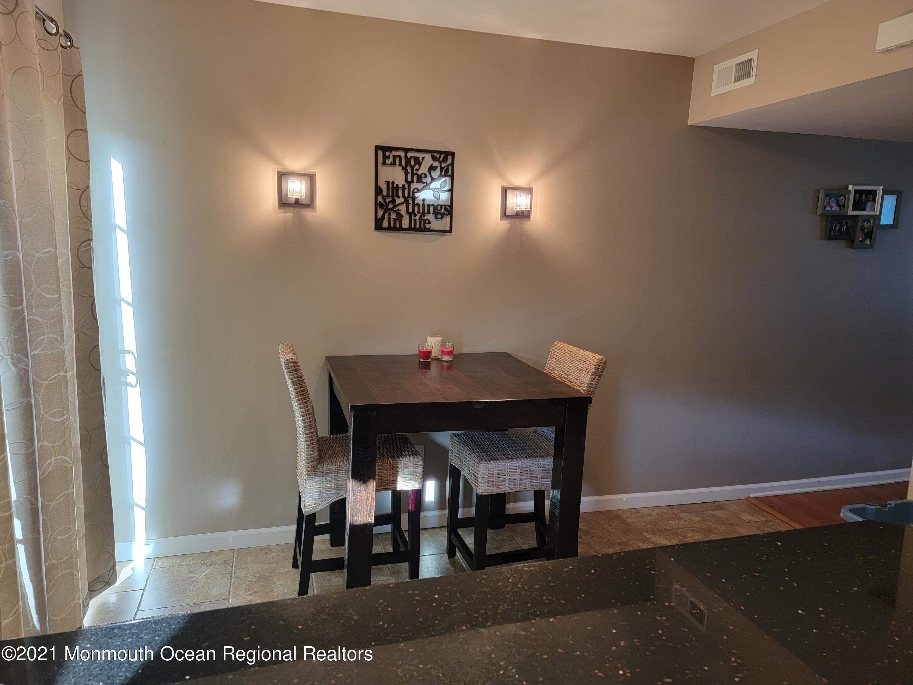 76 Greenwood Loop Road Brick, NJ 08724 - Photo 12 of 24 a dining room with a table and chairs