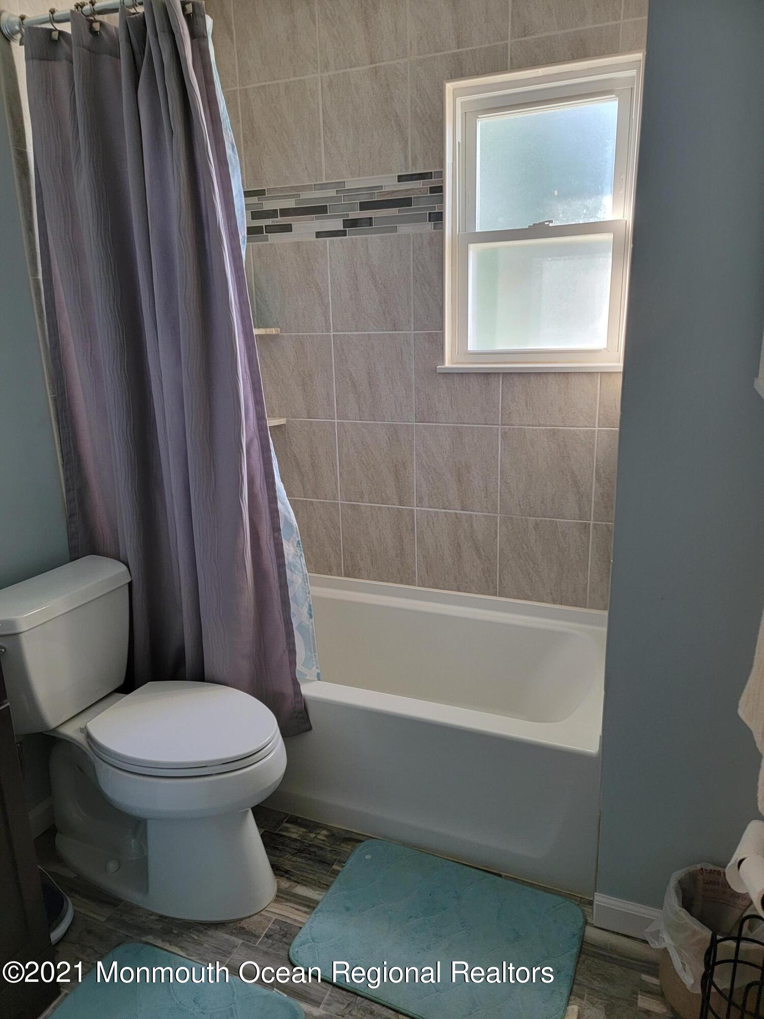 76 Greenwood Loop Road Brick, NJ 08724 - Photo 14 of 24 a white toilet sitting next to a bath tub