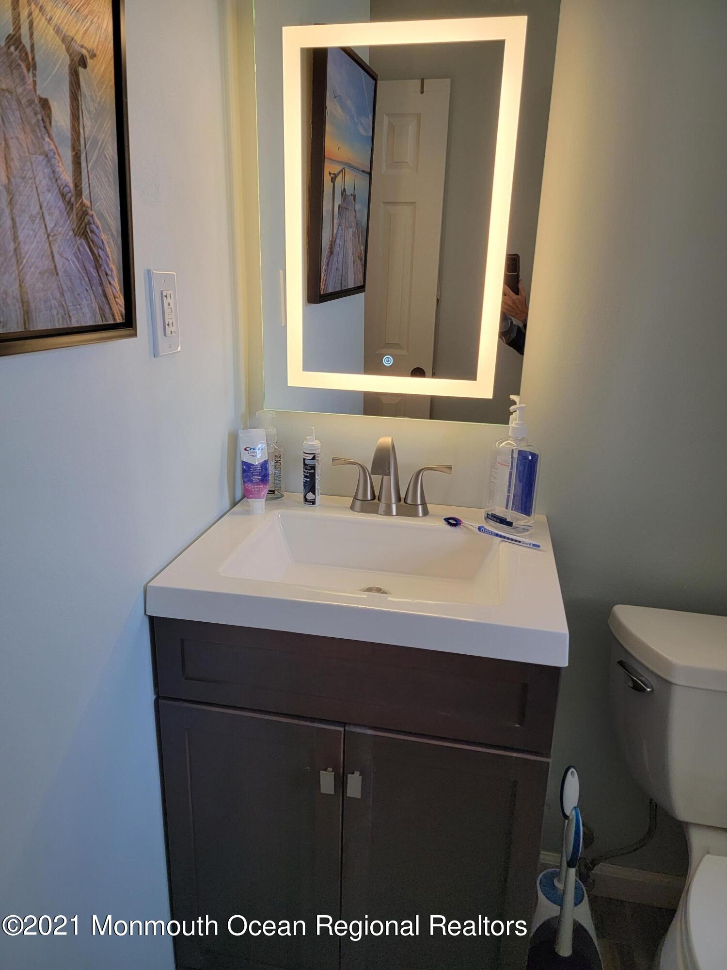 76 Greenwood Loop Road Brick, NJ 08724 - Photo 15 of 24 a bathroom with a sink and a toilet