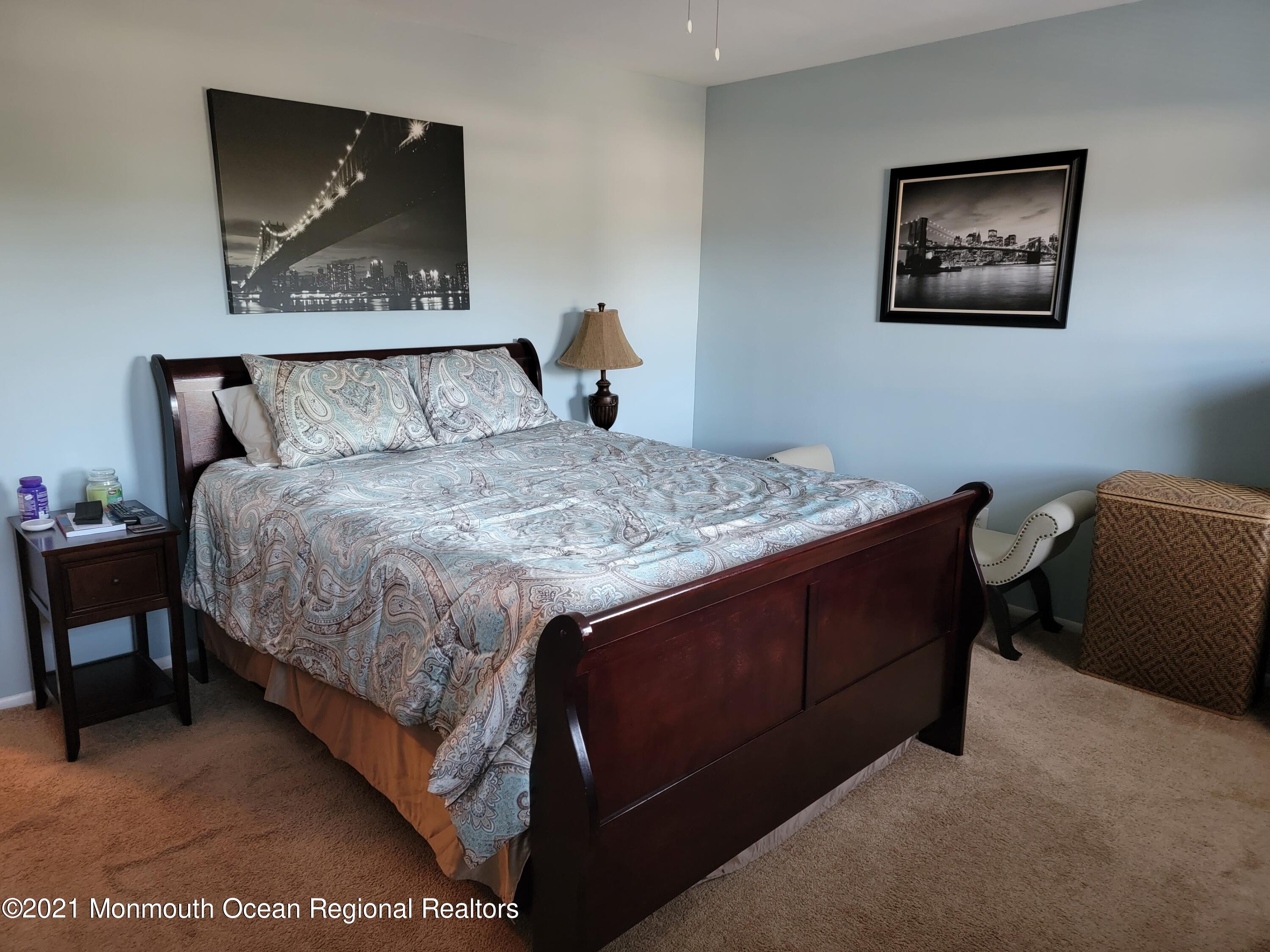 76 Greenwood Loop Road Brick, NJ 08724 - Photo 19 of 24 a bedroom with a bed and a painting on the wall
