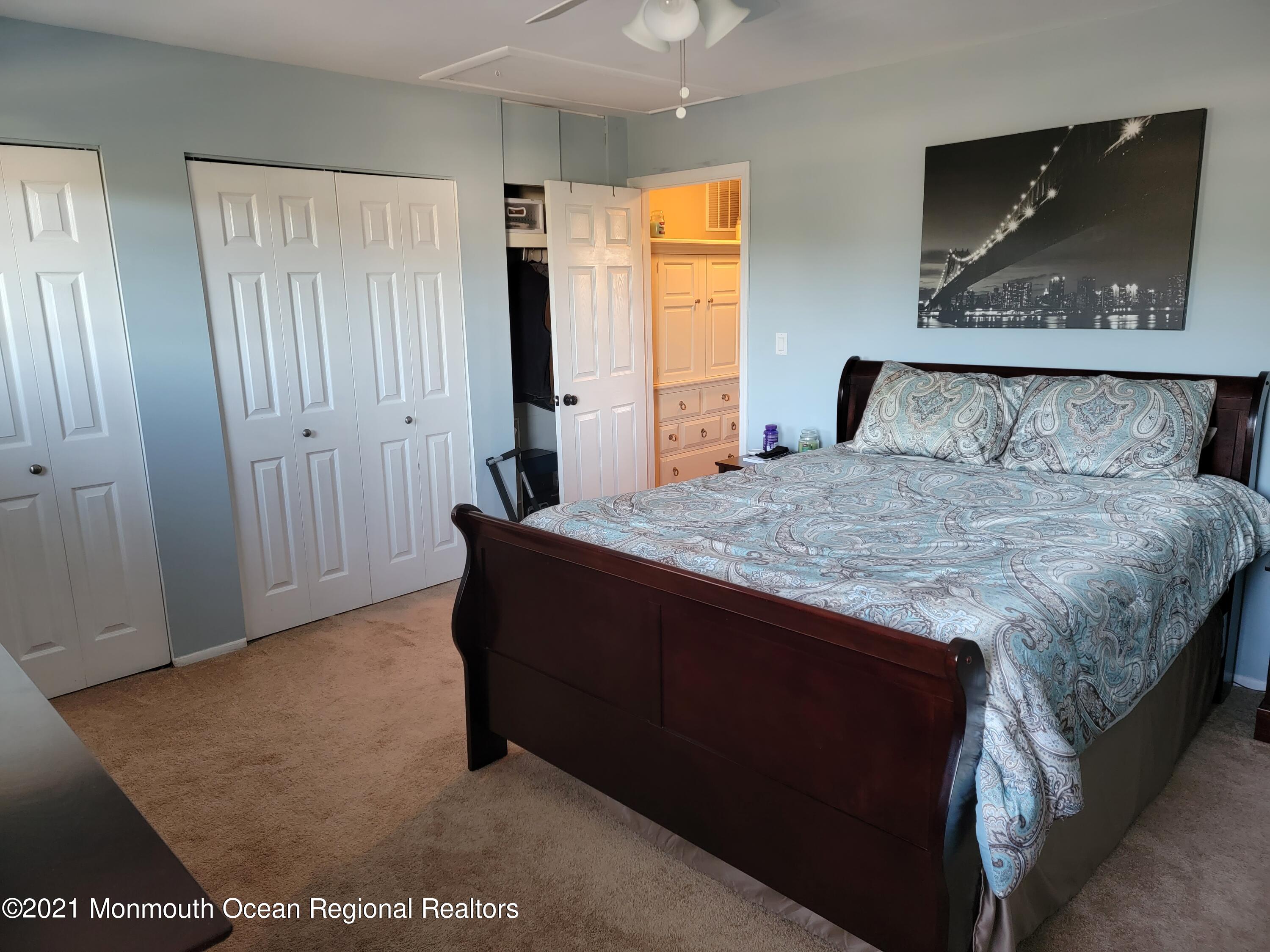 76 Greenwood Loop Road Brick, NJ 08724 - Photo 20 of 24 a bedroom with a bed and a painting on the wall
