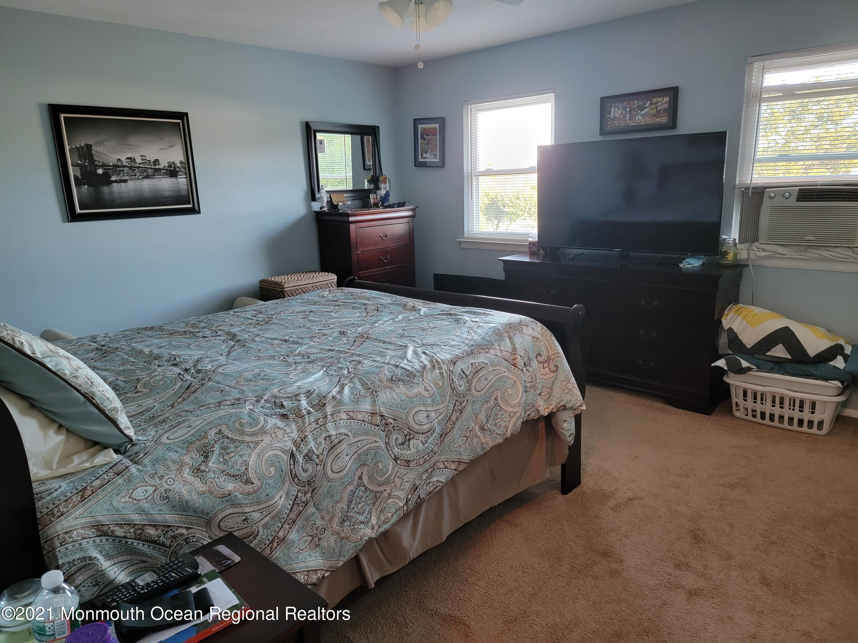 76 Greenwood Loop Road Brick, NJ 08724 - Photo 21 of 24 a bedroom with a bed and a window