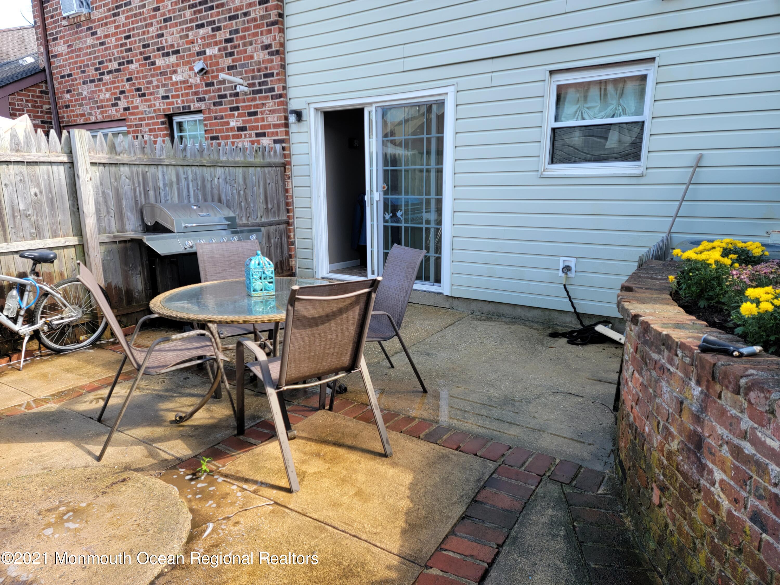76 Greenwood Loop Road Brick, NJ 08724 - Photo 22 of 24 a patio with table and chairs and potted plants