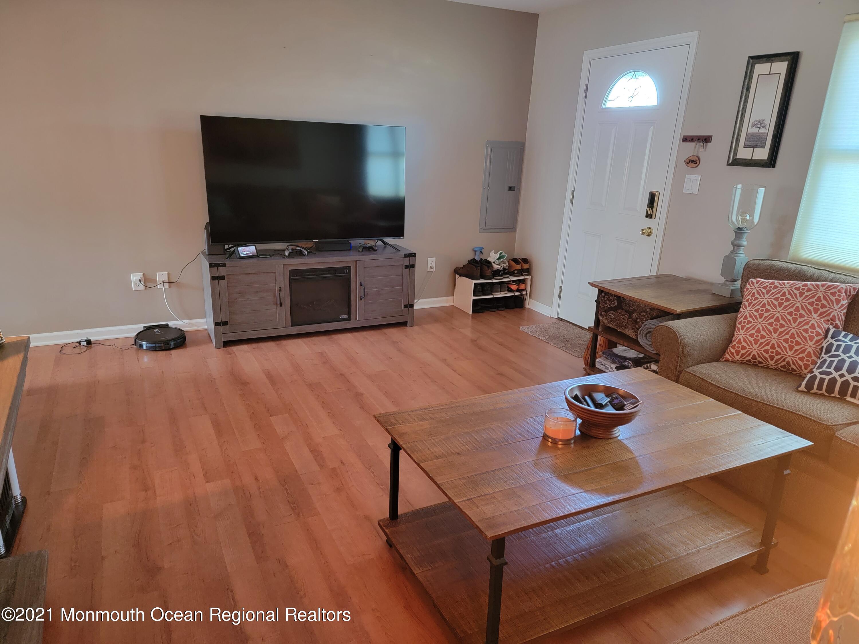 76 Greenwood Loop Road Brick, NJ 08724 - Photo 6 of 24 a living room with furniture and a flat screen tv