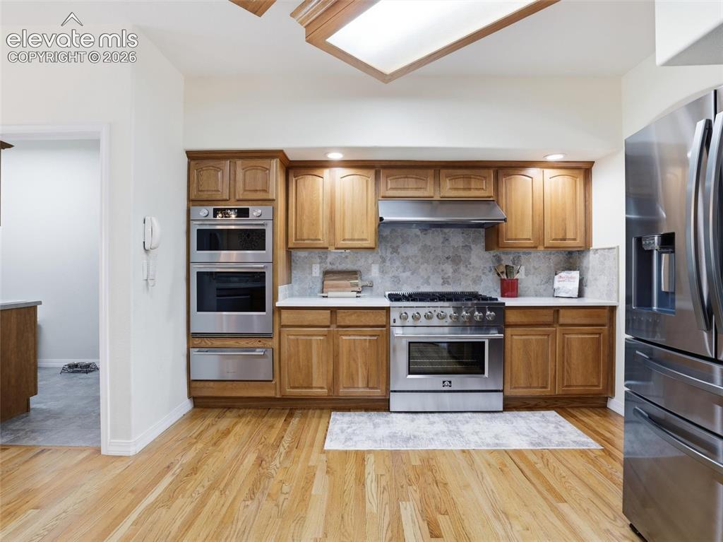 12855 Murphy Road Elbert, CO 80106 - Photo 6 of 50 a kitchen with stainless steel appliances granite countertop a refrigerator and a stove top oven