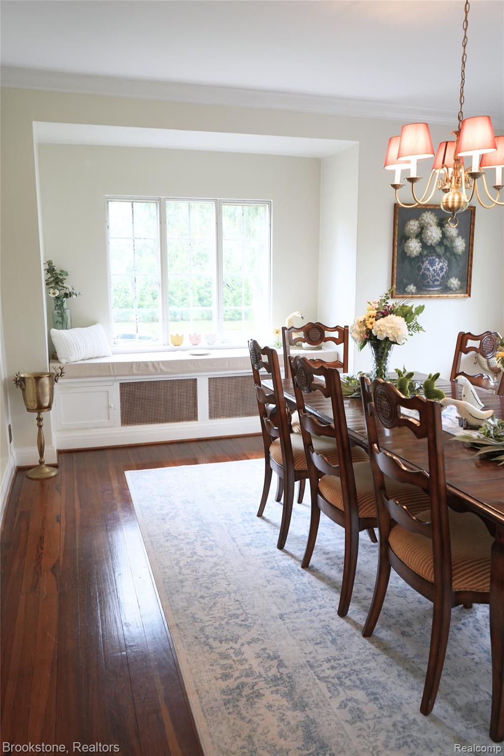 1840 Hampden Road Flint, MI 48503 - Photo 10 of 35 Dining area featuring a chandelier, dark wood-style flooring, and crown molding