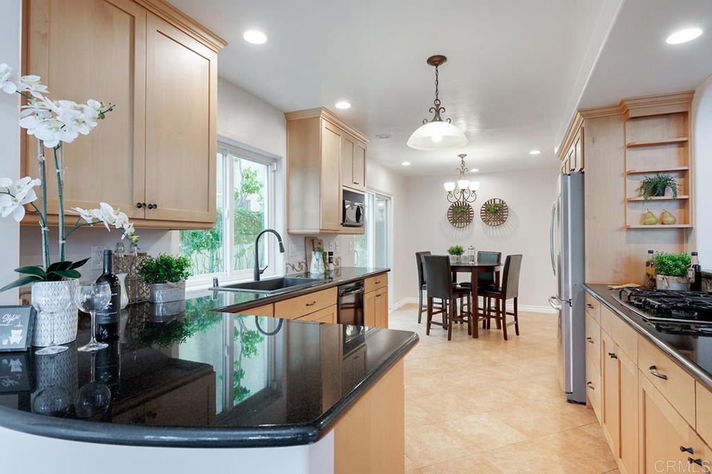 6 Admiralty Cross Coronado, CA 92118 - Photo 11 of 35 a kitchen with kitchen island granite countertop a stove and a sink