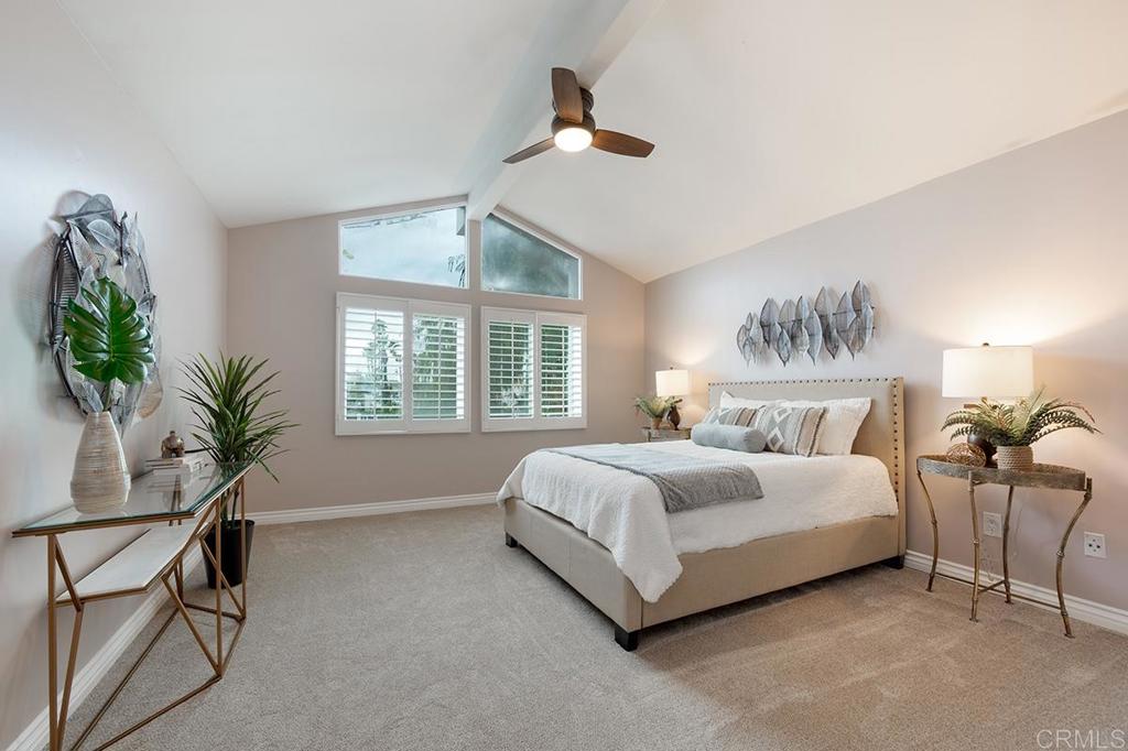 6 Admiralty Cross Coronado, CA 92118 - Photo 16 of 35 a spacious bedroom with a bed and a potted plant
