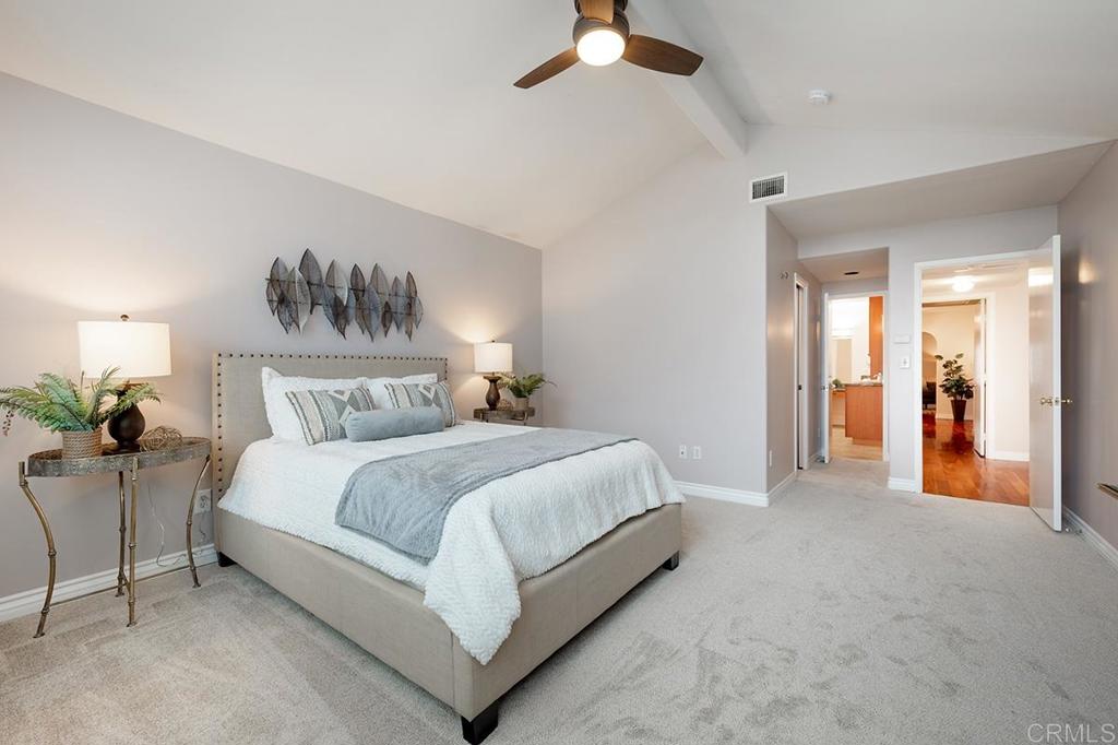 6 Admiralty Cross Coronado, CA 92118 - Photo 17 of 35 a spacious bedroom with a bed and a chandelier