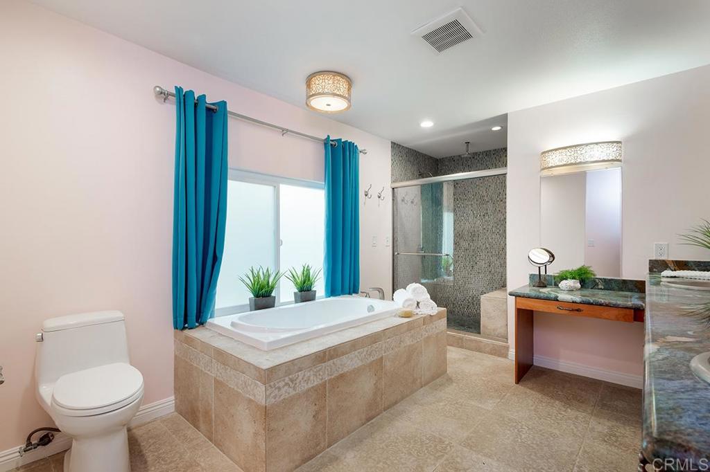 6 Admiralty Cross Coronado, CA 92118 - Photo 18 of 35 a spacious bedroom with a bed and a potted plant