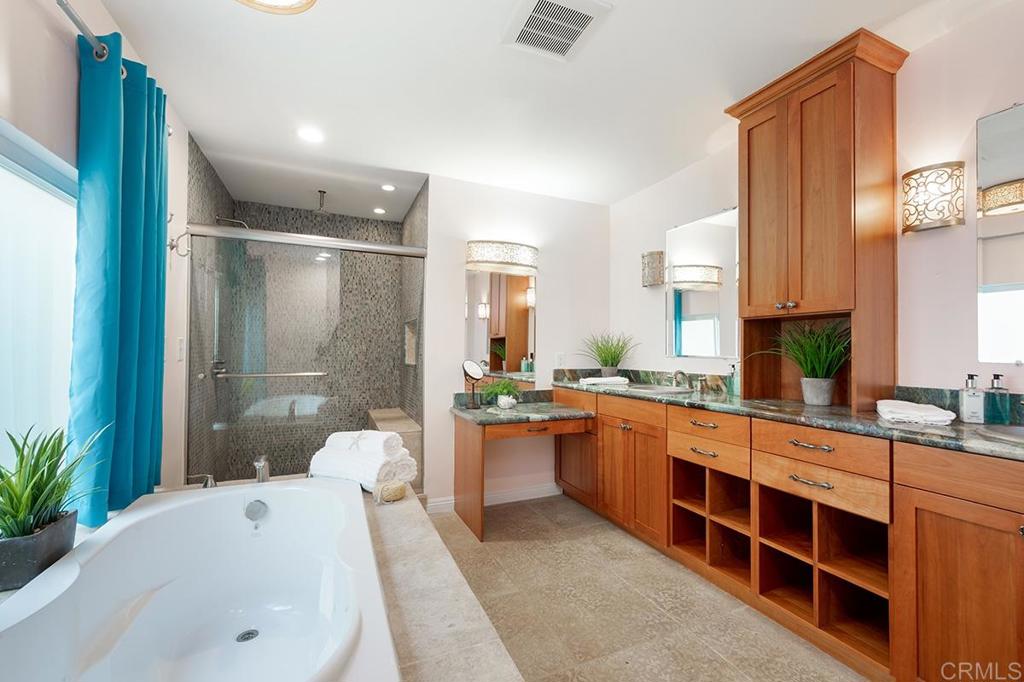 6 Admiralty Cross Coronado, CA 92118 - Photo 19 of 35 a large bathroom with a double vanity sink a large mirror and a bathtub