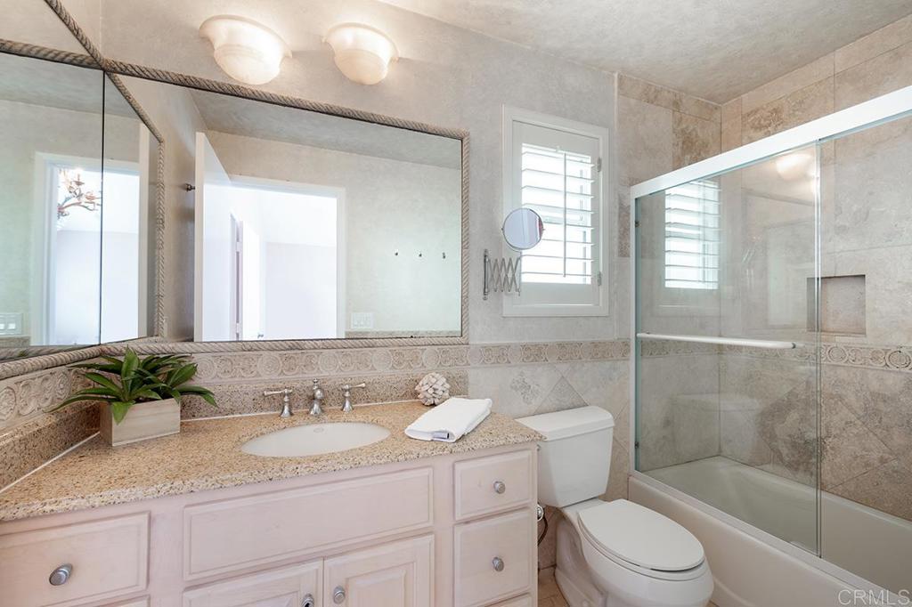 6 Admiralty Cross Coronado, CA 92118 - Photo 25 of 35 a bathroom with a granite countertop sink toilet and shower