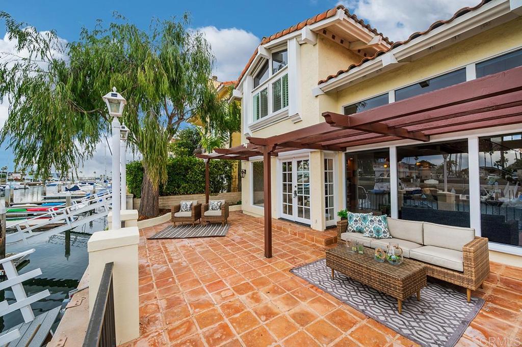 6 Admiralty Cross Coronado, CA 92118 - Photo 26 of 35 a view of a patio with couches and a table and chairs with garden view
