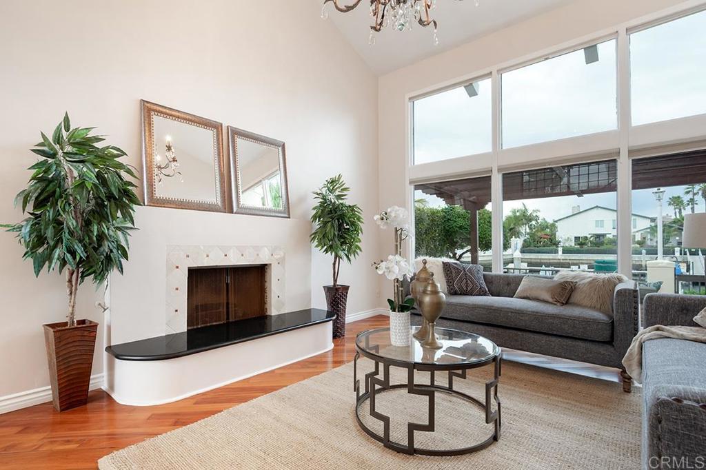 6 Admiralty Cross Coronado, CA 92118 - Photo 7 of 35 a living room with furniture a large window and a fireplace