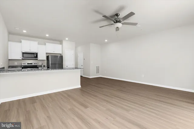 a view of a room with wooden floor