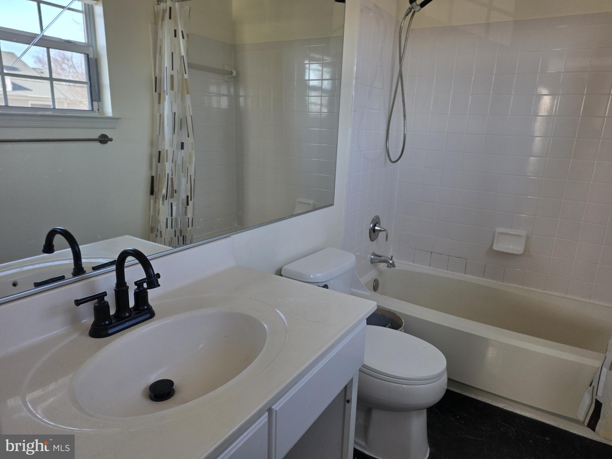 1037 Gardenview Loop, Unit 302 Woodbridge, VA 22191 - Photo 11 of 14 a bathroom with a sink a toilet and shower