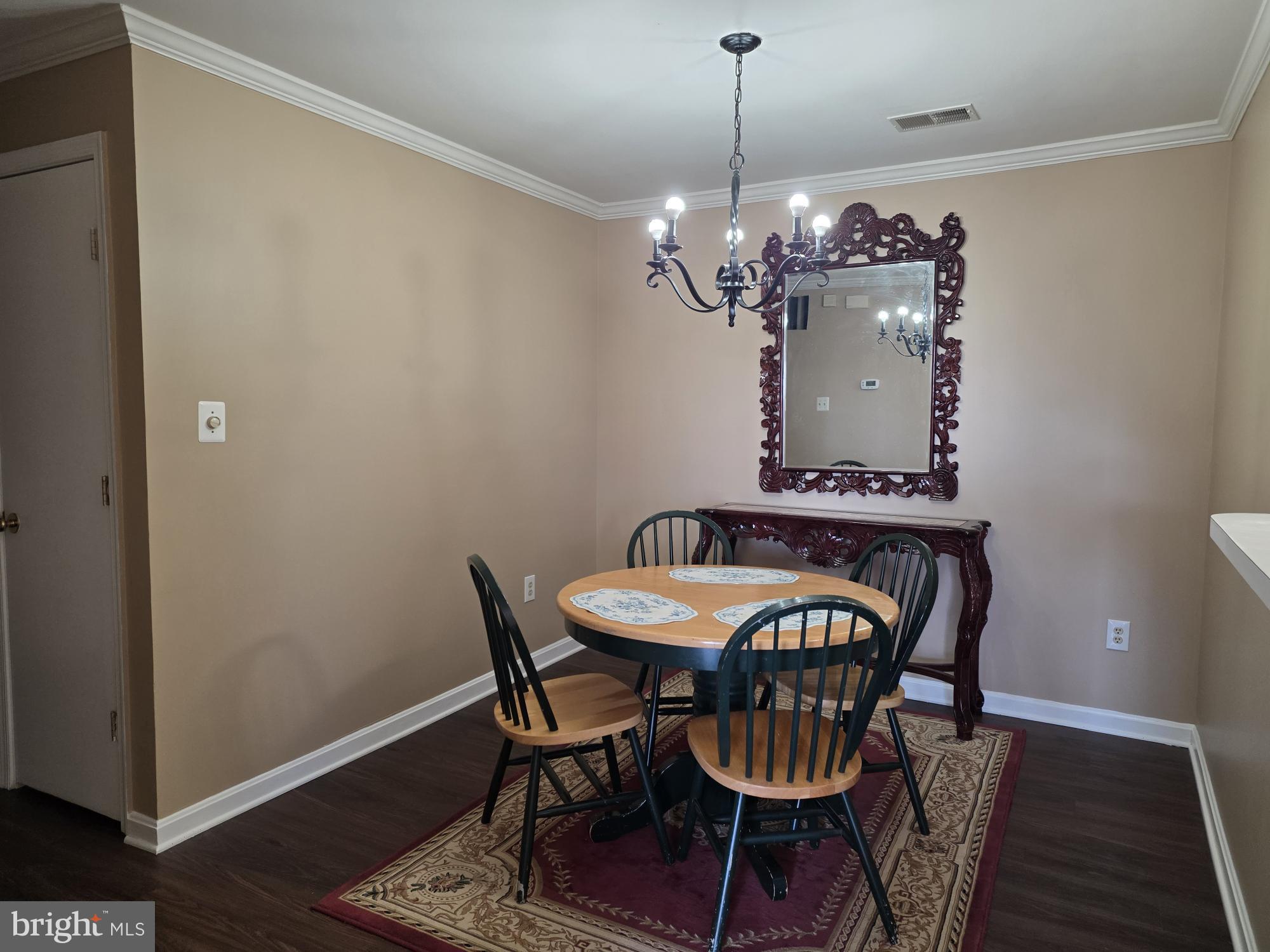 1037 Gardenview Loop, Unit 302 Woodbridge, VA 22191 - Photo 5 of 14 a view of a dining room with furniture and chandelier