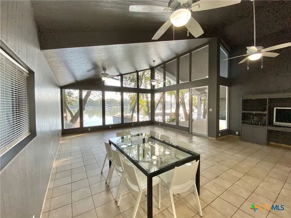 a room with lots of furniture and chandelier