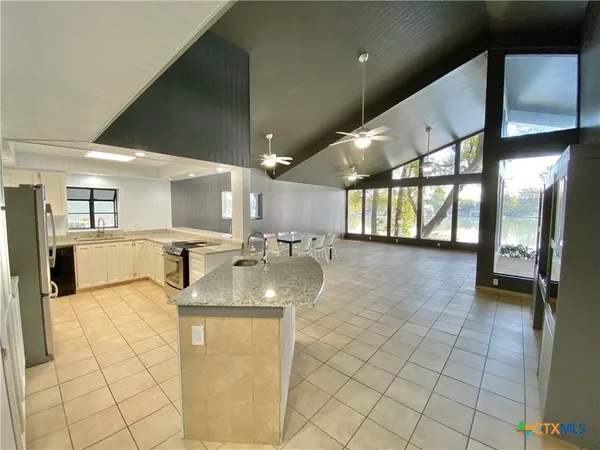 a view of a kitchen with a sink and chandelier