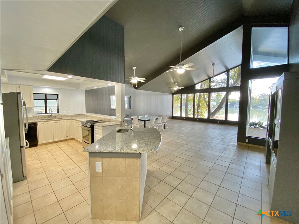 906 Lakeview Trail McQueeney, TX 78123 - Photo 3 of 13 a view of a kitchen with a sink and chandelier