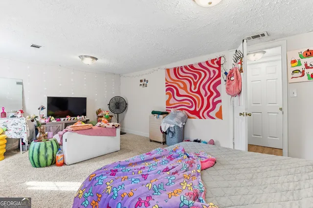 a bedroom with two beds and a bed