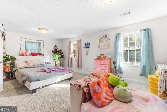 a bedroom with bed and a window