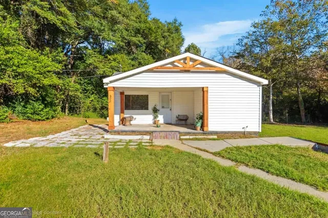 a view of a house with swimming pool and sitting area