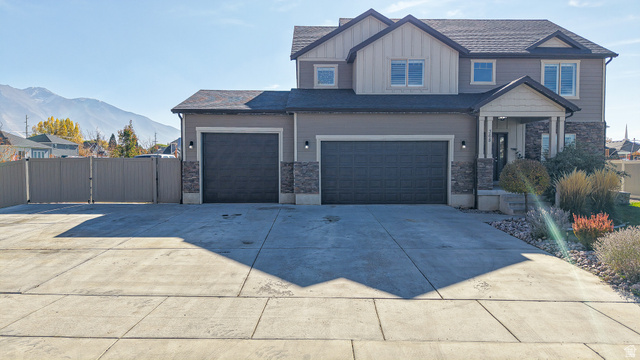 368 East 700 North Springville, UT 84663 - Photo 50 of 55 View of front of house with a gate, board and batten siding, stone siding, and concrete driveway