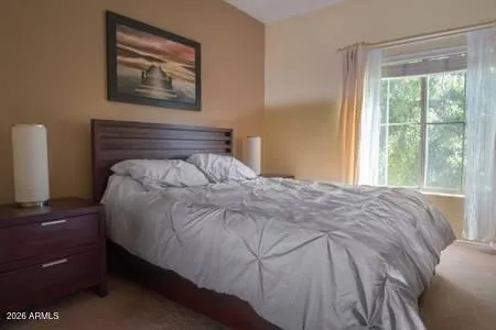 a bedroom with a bed and a window
