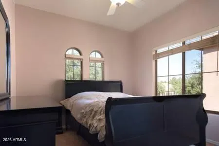 a bedroom with a bed and a window