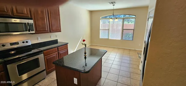 a kitchen with stainless steel appliances a stove microwave and sink