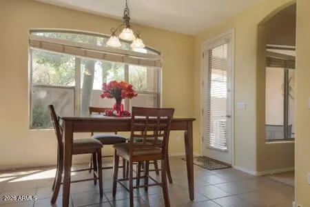 a view of a dining room with furniture wooden floor and chandelier