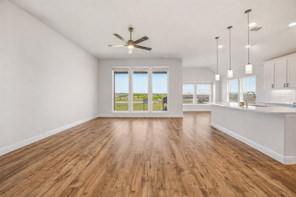 800 Jaguar Ridge Godley, TX 76044 - Photo 3 of 23 a view of an empty room with a window and wooden floor