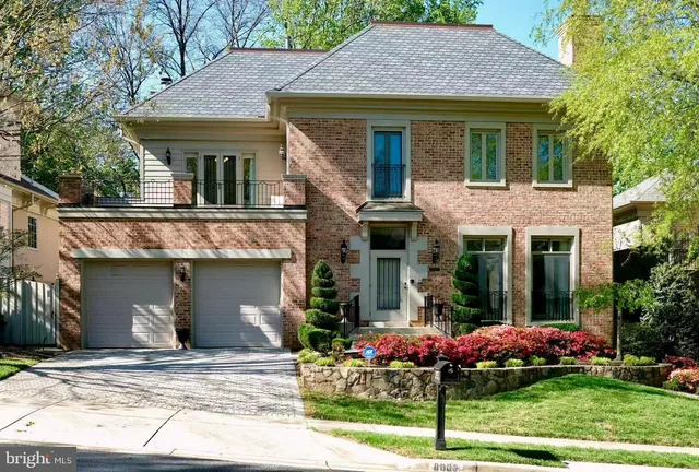a front view of a house with a garden