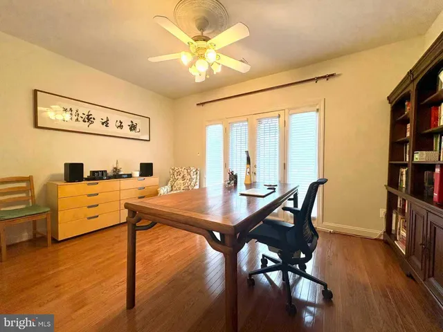 a view of a dining room with furniture and a book shelf