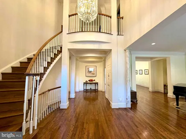 a view of a hallway view with wooden floor and staircase