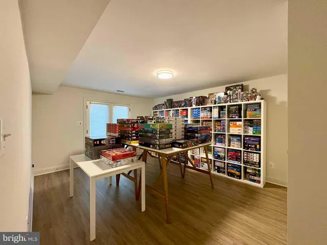 a view of a workspace with furniture and wooden floor