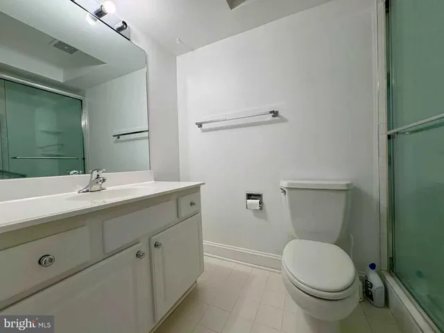 a bathroom with a sink toilet and mirror