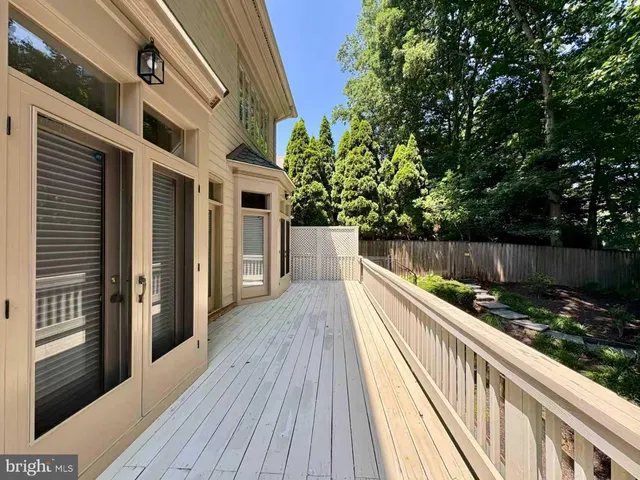 a view of balcony with wooden floor and fence